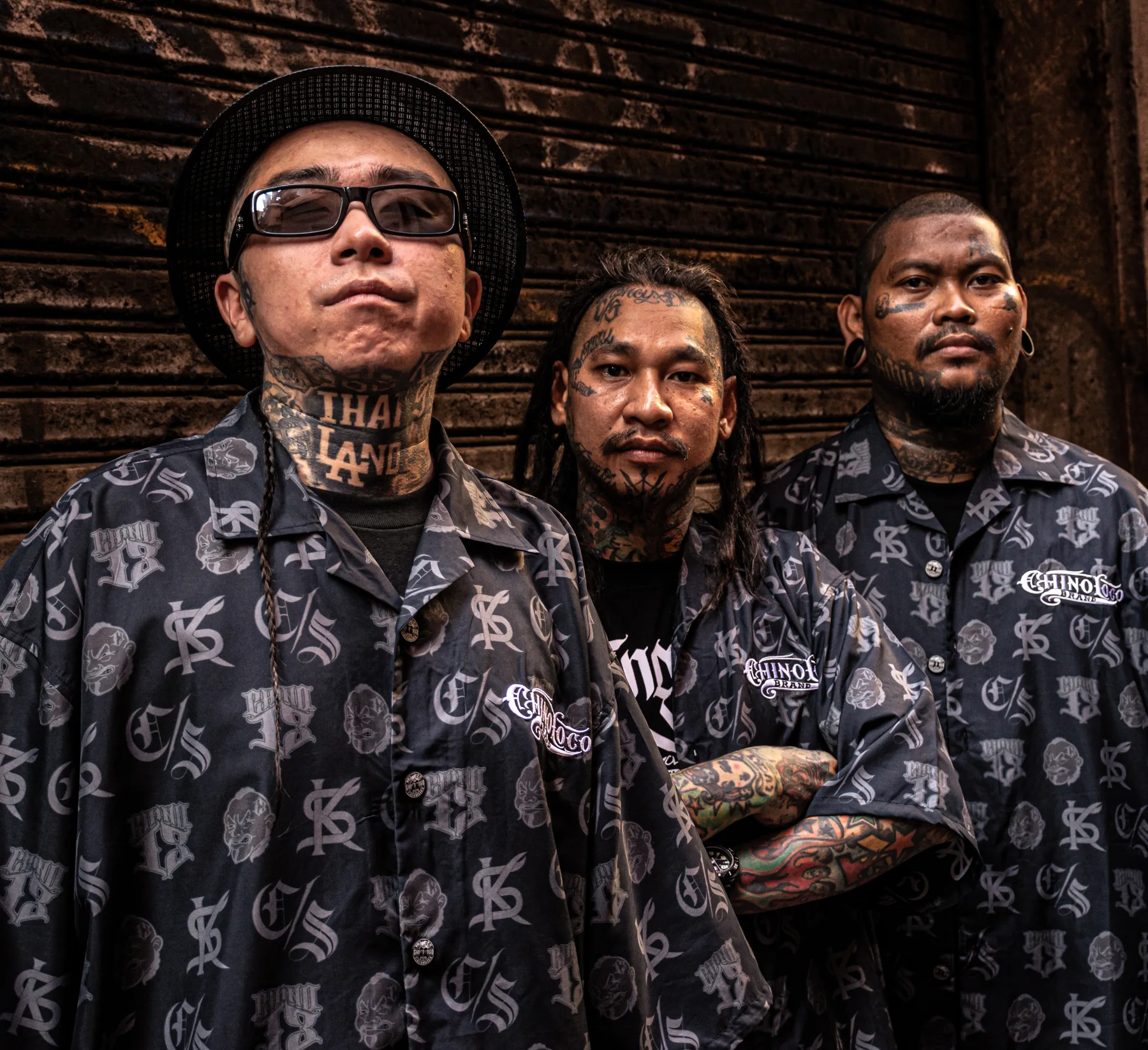 Three Asian Barrio brothers wearing matching patterned shirts
