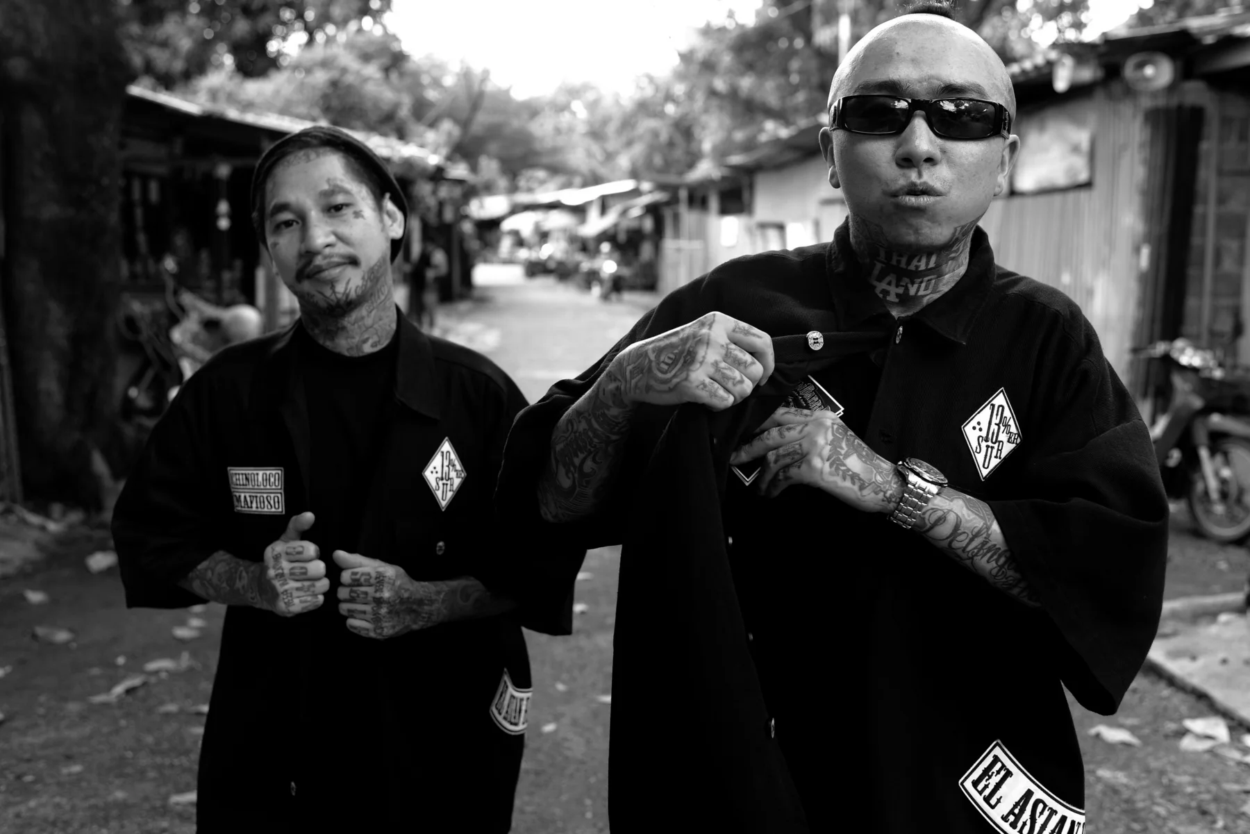 Two friends wearing Asian Barrio coach jackets outdoors