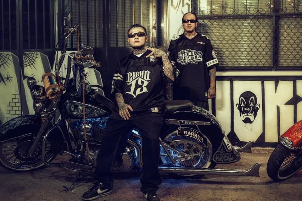 Asian Barrio brothers beside motorcycles at Liem Barber in Ho Chi Minh City