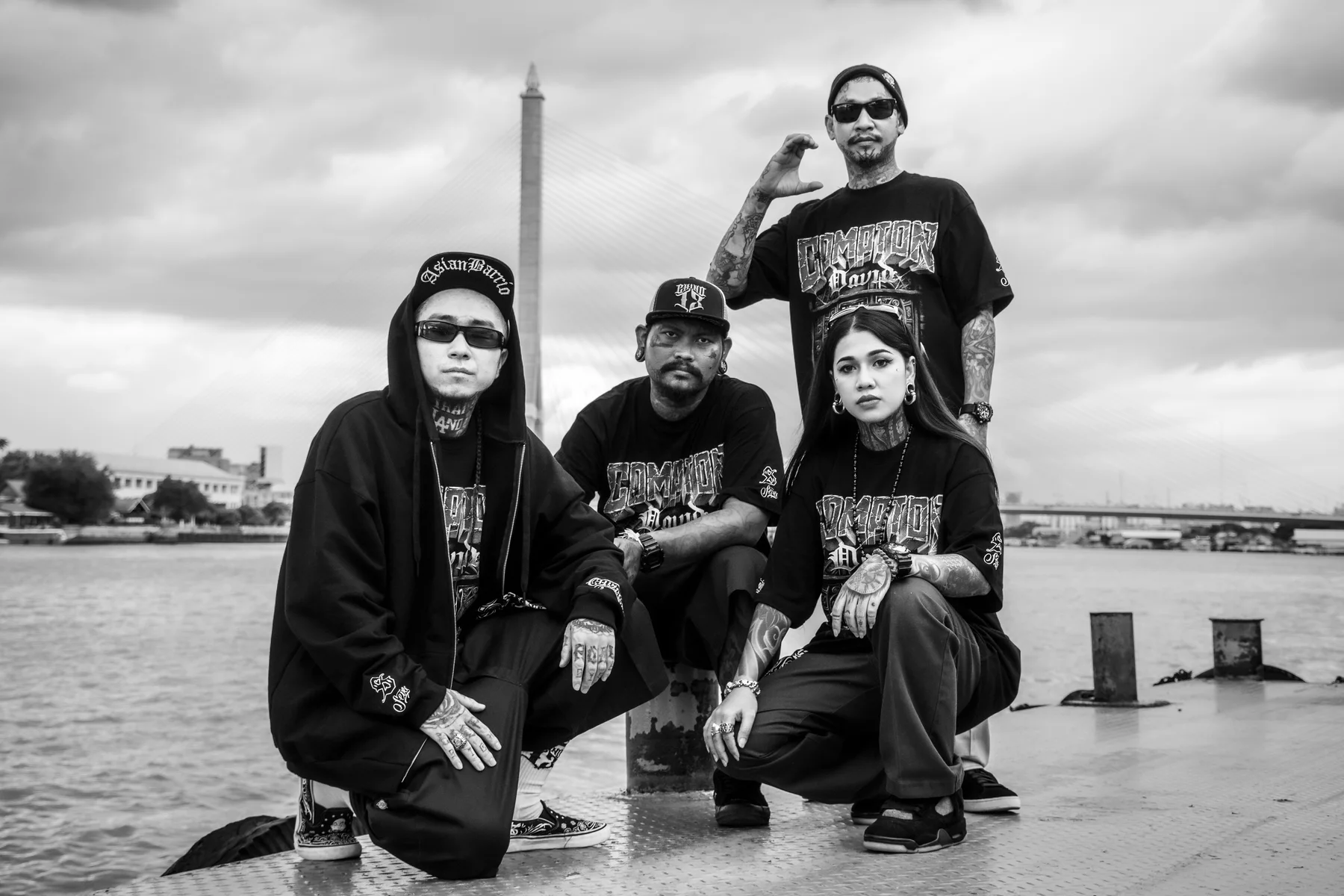 Four Asian Barrio friends posing together by the waterfront